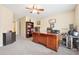 Home office with a large desk, built-in shelving, and neutral carpet at 1527 Sage Ridge Dr, Marietta, GA 30064