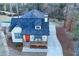 Aerial view of a charming cottage-style home with a bright orange front door and welcoming front porch at 5728 Williams Rd, Norcross, GA 30093