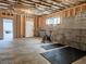 Unfinished basement area with concrete floors, block walls, an exterior door and exercise equipment at 5728 Williams Rd, Norcross, GA 30093