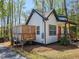 Charming two-story home with a wooden deck, bright orange door, and lush landscaping at 5728 Williams Rd, Norcross, GA 30093