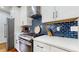 Modern kitchen with quartz counters, subway tile backsplash, and stainless steel appliances at 5728 Williams Rd, Norcross, GA 30093