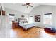 Vaulted ceiling primary bedroom with hardwood floors and natural light from large windows at 5728 Williams Rd, Norcross, GA 30093