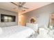 A well-lit bedroom with a tufted headboard, white dresser, a lighted mirror, and gray walls at 970 Sidney Marcus Blvd # 1217, Atlanta, GA 30324