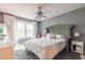 Bedroom featuring a tufted headboard, large windows with sheer curtains, and a ceiling fan at 970 Sidney Marcus Blvd # 1217, Atlanta, GA 30324