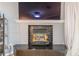 Close-up of a fireplace with a black tiled surround and a black mantel at 970 Sidney Marcus Blvd # 1217, Atlanta, GA 30324