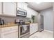Well-lit kitchen featuring stainless steel appliances, white cabinets, and stone countertops at 970 Sidney Marcus Blvd # 1217, Atlanta, GA 30324