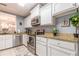 Bright kitchen with white cabinets, stainless appliances, granite countertops, and modern fixtures at 970 Sidney Marcus Blvd # 1217, Atlanta, GA 30324