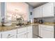 Updated kitchen with white cabinetry, granite countertops, stainless steel appliances, and a stylish faucet at 970 Sidney Marcus Blvd # 1217, Atlanta, GA 30324