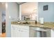 Kitchen featuring white cabinets, granite countertops, a stainless steel dishwasher, and a decorative backsplash at 970 Sidney Marcus Blvd # 1217, Atlanta, GA 30324