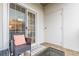 An outdoor patio area featuring a wicker chair, a table, sliding glass doors, and a storage closet at 970 Sidney Marcus Blvd # 1217, Atlanta, GA 30324