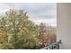 A skyline view from a balcony featuring tree tops, a highway, and buildings in the distance at 970 Sidney Marcus Blvd # 1217, Atlanta, GA 30324