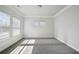 Light filled bedroom with neutral walls, carpet, and windows bringing plenty of sunlight at 1566 Winding Ridge Trl, Hoschton, GA 30548