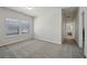 Bright bedroom with neutral walls, carpet, and ample natural light from the large double window at 1566 Winding Ridge Trl, Hoschton, GA 30548