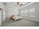 Comfortable bedroom featuring a trey ceiling, carpet, and multiple windows offering plenty of light at 1566 Winding Ridge Trl, Hoschton, GA 30548
