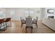Sunlit dining area with hardwood floors and modern decor adjacent to the kitchen at 1566 Winding Ridge Trl, Hoschton, GA 30548