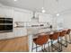 Bright kitchen boasts granite countertops, modern appliances and seating at the island at 1566 Winding Ridge Trl, Hoschton, GA 30548