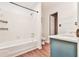 Well-lit bathroom features a tub/shower combo, white tile, and a blue vanity with a bright white countertop at 808 Riverview Se Dr, Marietta, GA 30067