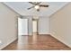 Neutral bedroom featuring ceiling fan, wood floors, and freshly painted walls at 808 Riverview Se Dr, Marietta, GA 30067