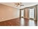 Bedroom features a ceiling fan, two windows with curtains, and attractive wood-look flooring at 808 Riverview Se Dr, Marietta, GA 30067