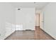 Bright bedroom with wood-look flooring, a white door, and neutral walls creating a calming space at 808 Riverview Se Dr, Marietta, GA 30067