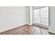 Bright bedroom featuring a large window with blinds and attractive wood-look flooring throughout at 808 Riverview Se Dr, Marietta, GA 30067