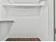 A white empty closet with wood floors featuring a metal hanging rack and shelf at 808 Riverview Se Dr, Marietta, GA 30067