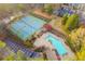 Aerial view of a swimming pool, tennis courts and lush landscaping at 808 Riverview Se Dr, Marietta, GA 30067