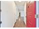 Entryway featuring a red front door opening to a hallway with neutral walls and dark wood-look floors at 808 Riverview Se Dr, Marietta, GA 30067