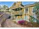 Exterior view of townhomes with outdoor patios, lush landscaping and multiple floors at 808 Riverview Se Dr, Marietta, GA 30067