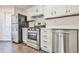 Bright kitchen featuring stainless steel appliances, white cabinetry, and dark hardware accents at 808 Riverview Se Dr, Marietta, GA 30067