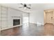 Spacious living room with a fireplace, built-in shelving, dark wood-look floors, and sliding glass door at 808 Riverview Se Dr, Marietta, GA 30067