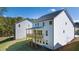 Back exterior view of home with wooden deck and lots of green space at 1871 Lacebark Elm Way, Lawrenceville, GA 30045