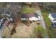 An aerial view of a property showcasing a well-kept lawn, landscaping and a long driveway with parking at 532 Rivercrest Dr, Woodstock, GA 30188