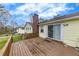 View of the rear exterior of the home showing the spacious wooden deck and sliding glass door at 532 Rivercrest Dr, Woodstock, GA 30188