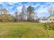 Large backyard featuring lush greenery, mature trees, and a well-maintained lawn at 532 Rivercrest Dr, Woodstock, GA 30188