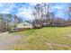 Spacious backyard with mature trees surrounding the back of the house at 532 Rivercrest Dr, Woodstock, GA 30188