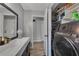 Bathroom includes a double vanity and built in storage alongside laundry area at 532 Rivercrest Dr, Woodstock, GA 30188