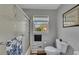Bright bathroom featuring a tub-shower combination, toilet and a window at 532 Rivercrest Dr, Woodstock, GA 30188