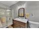 Bathroom with a glass enclosed shower, a sink with a marble top and a wooden cabinet at 532 Rivercrest Dr, Woodstock, GA 30188