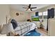 Cozy bedroom with hardwood floors, a ceiling fan, natural light, and a comfortable bed at 532 Rivercrest Dr, Woodstock, GA 30188