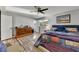 Bright bedroom featuring hardwood floors, a ceiling fan, and a cozy seating area at 532 Rivercrest Dr, Woodstock, GA 30188