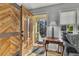 Inviting foyer with wood door and herringbone accent wall, blending rustic charm with modern elegance at 532 Rivercrest Dr, Woodstock, GA 30188