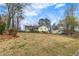 Traditional yellow home with a well-kept lawn and mature trees, offering a serene suburban setting at 532 Rivercrest Dr, Woodstock, GA 30188