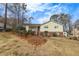 Inviting yellow home on a grassy lawn, showcasing mature trees and classic suburban charm at 532 Rivercrest Dr, Woodstock, GA 30188