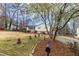Suburban home with lush green lawn and surrounding trees in a peaceful, Gathering-friendly neighborhood at 532 Rivercrest Dr, Woodstock, GA 30188