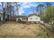 Charming home featuring a well-manicured front yard, with a quaint front porch and a tidy, landscaped garden at 532 Rivercrest Dr, Woodstock, GA 30188