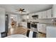 Modern kitchen with white cabinets and stainless steel appliances adjoins to the dining room at 532 Rivercrest Dr, Woodstock, GA 30188