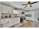 Bright kitchen features white cabinets, granite counters and stainless steel appliances at 532 Rivercrest Dr, Woodstock, GA 30188