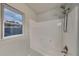 Bathroom featuring a tub and shower combination with white surround and a framed window at 634 Sandpiper Cv, Stockbridge, GA 30281