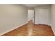 Bedroom with sleek hardwood floors and neutral walls, leading to a closet or ensuite at 634 Sandpiper Cv, Stockbridge, GA 30281